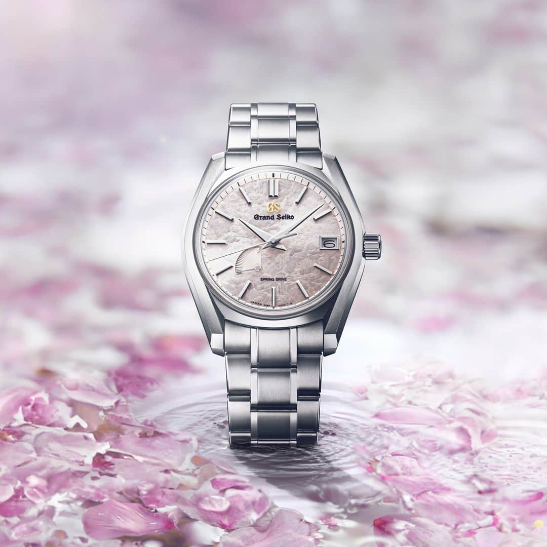 Grand Seikoのインスタグラム：「【Heritage Collection #SBGA413 】  The pink dial of this model captures the spirit of the fleeting sakura season.  Hana-ikada, the rafts of blossoms- when sakura blossoms fall into water, they swirl and float. The pink blossoms dance on the water, and the Japanese call them flower rafts, hana-Ikada.  To look closely at the dial is to be transported to Hana-Ikada, the much-loved scene at the moment soon after the spring equinox, Shunbun when cherry blossom petals scattered by the wind cover the surface of a river. The textured dial and its pale pink color capture the magic of this treasured moment in the Japanese calendar and not only express the beauty of Sakura but hint at the exquisite pleasure to be derived from a profound understanding of the ephemeral nature of time.  #grandseiko #thenatureoftime #aliveintime」