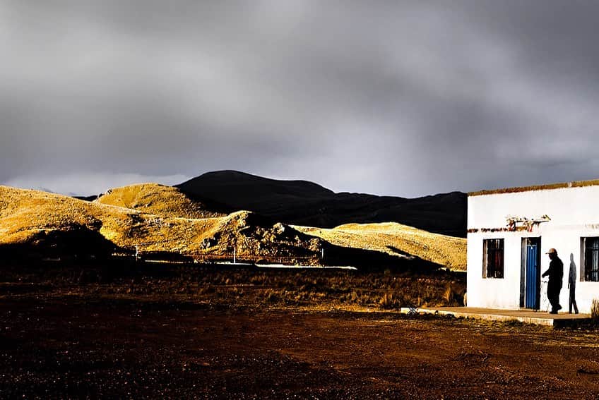 Robert Clarkのインスタグラム：「A lone farm worker walks into a store near Ayacucho, Peru. I find the landscape and the people of the Andes, to me, the most beautiful place I have ever visited. I have traveled to the Andes on nearly a dozen stories for @natgeo starting in 1997 until 2019. I think the Andes, Peru, Bolivia & Ecuador are magic.」