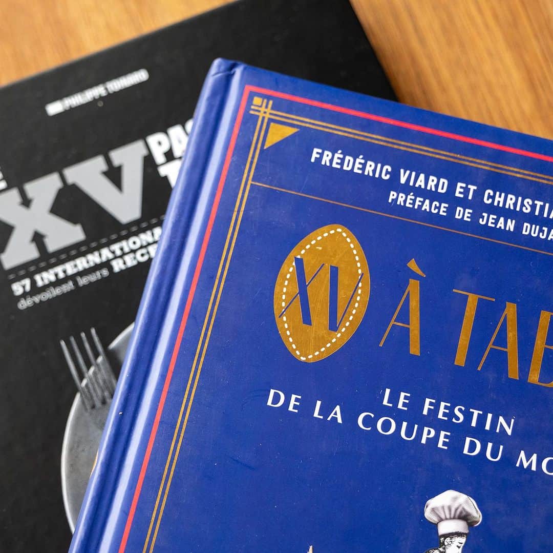 武井義明さんのインスタグラム写真 - (武井義明Instagram)「amazon.frで買った料理本が２冊届いた。『XV à table: Le festin de la coupe du monde』（ワールドカップの饗宴）と『Le XV passe à table: 57 joueurs de léquipe de France dévoilent leurs recettes favorites』（フランス代表57選手がお気に入りのレシピを公開）「XV」ってのは15で、ラグビーをあらわし、「Le XV de France」だと「ラグビーワールドカップフランス代表」ってことみたいね。スポーツイベント便乗本にしてはつくりが本格的（大型、ハードカバー、オールカラー）で、「ワールドカップにかこつけているのかもしれないが、料理本として本気でつくっているのではないか」「というかフランスの料理本の底力ってこういうことじゃないか」と思い、買ってみたんです。そしてその通りでした。すごいな。一冊は料理担当がChristian Etchebest氏（ラ・カンティーヌ・デュ・トロケの）。  （追記）本の紹介はこんな感じ。  『XV à table: Le festin de la coupe du monde』（ワールドカップの饗宴）  「フィールドでもテーブルでもラグビーを！」 ラグビーは、フィールドでの逞しさと、外での和気あいあいとした絶対的な愛情を常に併せ持つ唯一のスポーツである。  "Fourchette"（フォーク）、"cocotte"（鍋）、"rosbif"（ローストビーフ）、"cuillère"（スプーン）、これらの言葉は、料理とラグビーが常に手を取り合ってきたことを示している（＊）。  ＊"Fourchette"（フォーク）は、相手の目を狙うこと。フランスでは歴史的に寛容らしいが英国では嫌悪されている。／"cocotte"（鍋）これは南アフリカ出身でフランスで活躍したラグビー選手Rory Kockottのことか？／"rosbif"はフランスで英国ラグビーを揶揄する言葉／"cuillère"はトーナメントの最下位のチームに贈られる不名誉な「木のスプーン」をさすらしい。「料理とラグビーが常に手を取り合って」という感じではありませんが‥‥。  有名なシェフでビストロノミーの考案者であるクリスチャン・エチェベストと、有名なスポーツ・ジャーナリストであるフレデリック・ヴィアールが、約20の国際チームのラグビーと料理の伝統、そしてファンが一緒に楽しめるように考案された世界中の40のレシピを紹介。  @christianetchebest   ──────────────────────────  『Le XV passe à table. 57 joueurs de l'équipe de France dévoilent leurs recettes favorites』（フランス代表がテーブルにつく。フランス代表57選手がお気に入りのレシピを公開）  2023年ラグビーワールドカップ・フランス大会のキックオフにふさわしい、美しいグルメ本。  フランス代表の選手たちがローストビーフを切り分けたり、キャラメルや洋ナシ、栗を配ったりするのが好きなら、彼らはその調理法も知っている。第10回ラグビー・ワールドカップに合わせ、57人のフランス代表の現役選手と元選手が、前菜、メインディッシュ、デザートなど、お気に入りのレシピを披露。伝統的な鴨胸肉とポテトのソテーから、典型的なクネル・リヨネーズ、心地よいグラタン・ドフィノワ、レモン風味のジューシーなチキン・タジン、そして驚愕のマルバ・プディングも忘れてはならない。青いジャージからキッチンエプロンに着替えたラグビー選手たちによる、気前がよくコスモポリタンな57のレシピが見事にミックスされている。  『180 °C』『12°5』という雑誌の編集長であり（＊）、ラジオ、テレビ、新聞などの料理コラムニストでもあるフィリップ・トワナールが、このプロジェクトを支えている。彼はこの本に登場する57人の国際的な選手たちに会いに行き、お気に入りのレシピを聞き、彼らの最高の思い出を語ってくれた。  @philippetoinard   （＊）『180 °C』は料理の、『12°5』はワインの雑誌。 https://www.180c.fr/  各選手の写真は、写真家兼アートディレクターのヴァンサン・バルデンスペルガーが撮影した。  @baldensperger_photographies」11月15日 12時05分 - bebechef