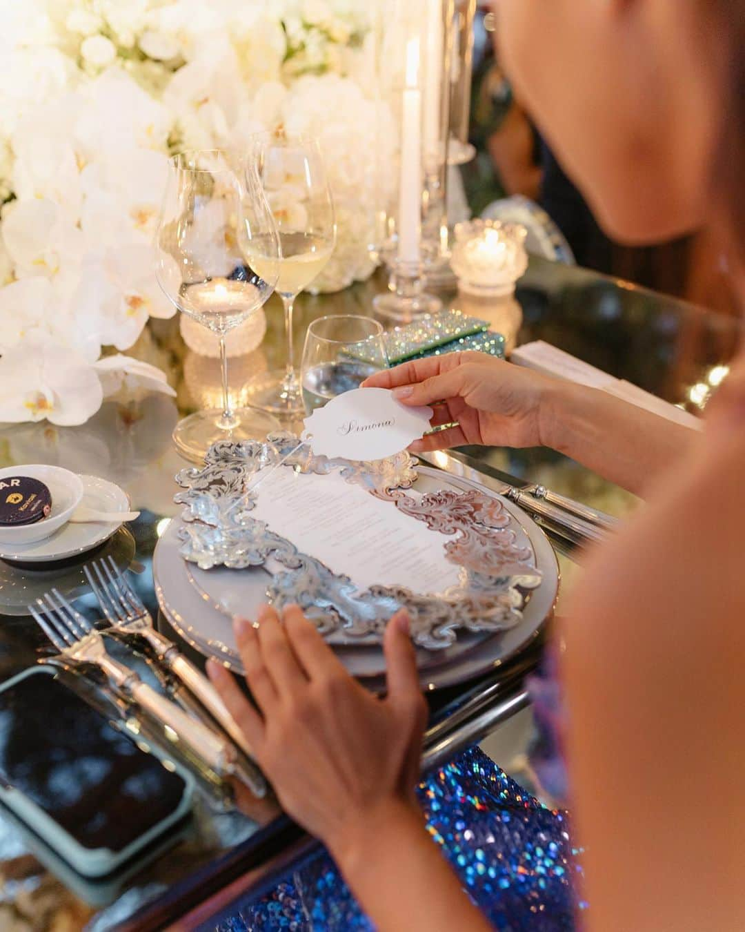 Ceci Johnsonさんのインスタグラム写真 - (Ceci JohnsonInstagram)「WEDDING | S&A’s wedding day unfolded like a dream, resembling a white cloud flower fantasy. In harmony with the theme, we designed the napkins, menu, and invitation page in a palette of white and silver. The invitation itself showcased their wedding day florals, transitioning guests from paper to reality. For the reception, we crafted a menu featuring a silver mirror laser-cut border surrounding a white acrylic center, drawing inspiration from French brocade patterns. Complementing this, silver-embroidered napkins adorned with their monogram added the perfect finishing touch.  #CeciCouture ⠀⠀⠀⠀⠀⠀⠀⠀⠀ CREATIVE PARTNERS Planning & Design: @lavenderandroseweddings Luxury Invitation & Event Branding: @cecinewyork Venue & Catering:  @fscapferrat Cake: @bastien_blanc_tailleur Photography: @daniloandsharon Videography: @chromata_films_weddings Production: @deco_flamme Tableware: @latinidesign @maison_options Floral Design: @roni_floral_design Music:  @qart.events @alexandramillerinsta @adilmaksutovic @cecaraznatovic @cobi.v Entertainment: @nuart_events @prodiammclescure @pyrokervenka @blackbirdcage @houseofpyramid ⠀⠀⠀⠀⠀⠀⠀⠀⠀ #cecinewyork #ceciwedding #lavenderandroseweddings #luxuryinvitations #elegantdesigns #coutureinvites #opulentdetails #bespokeinvitations #chiccelebrations #artistryininvitations #highenddesigns #luxurystationery #premiuminvitations #exquisitedetails #invitationelegance #celebrateinstyle #glamorousinvites #luxurycelebrations #finestationery #customizedelegance #celebrationperfection #invitationcouture #elevateyourevent #luxuryeventplanning #unforgettableinvites」11月15日 23時48分 - cecinewyork