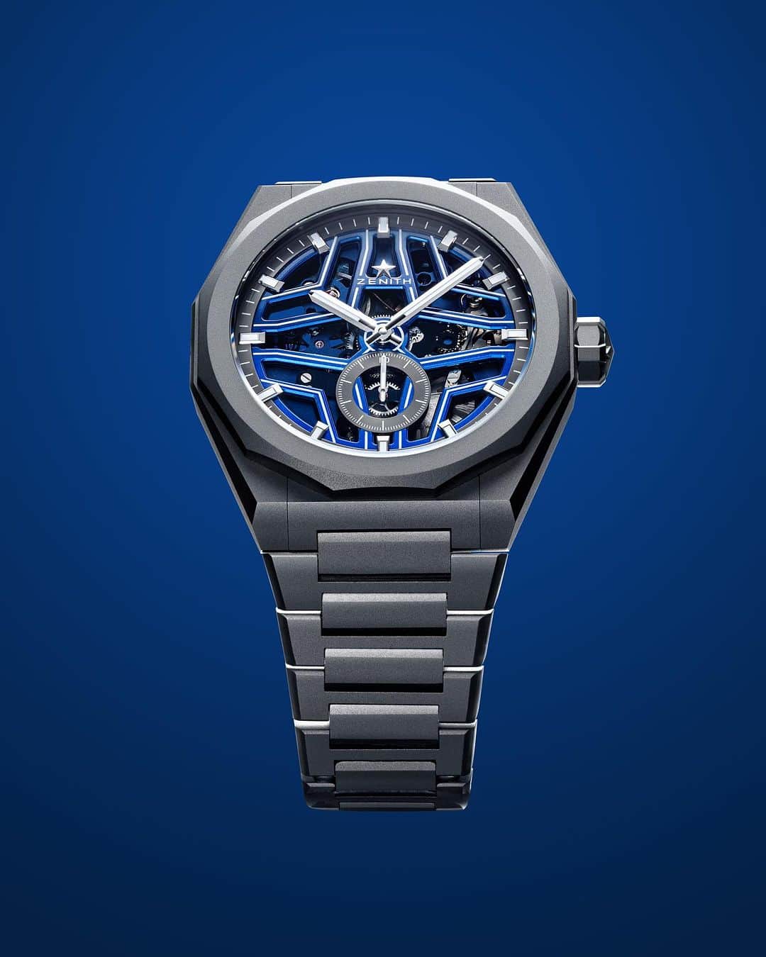 ゼニスのインスタグラム：「New: The brightest star on the horizon.⭐ The #DefySkylineSkeleton Night Surfer #ElPrimero, in partnership with @timetidewatches, captures the magnificence of the darkening night sky and the ocean in a micro-blasted titanium case, paired with a liquid blue gradient dial. Its open star-shape is highlighted with luminescent lines that come to life in the dark, making the star motif brighter, while highlighting the 1/10 of a second El Primero movement. A limited-edition of 200 pieces, available exclusively as of November 22nd in ZENITH online boutiques worldwide, and on #TimeAndTide's online store.🌊」
