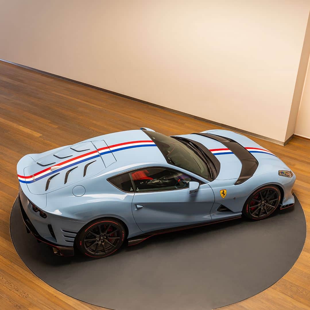 フェラーリのインスタグラム：「This #Ferrari812Competizione, created thanks to the #FerrariTailorMade programme evokes some of the past Ferrari’s victories through its livery stripe. The reference reappears on the steering wheel, highlighting Ferrari’s racing heritage.   The Scuderia Ferrari shield is the cherry on the top, embellishing the headrests of the seats with a square quilt pattern of red Aunde Jeans upholstery.  #Maranello #Ferrari」