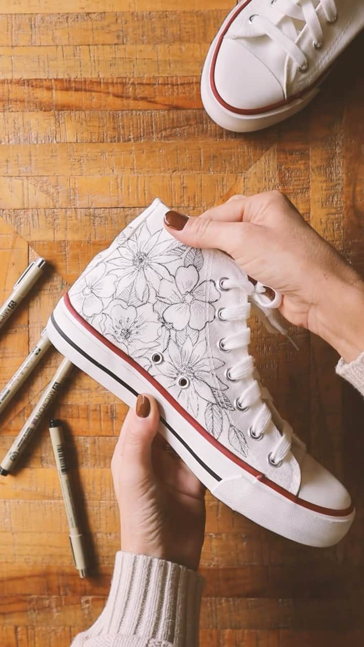 Sakura of America（サクラクレパス）のインスタグラム：「Hello again! Karla here from @lovekdesigns. As promised, here’s a little DIY Floral Sneaker project I worked on using my Micron pens!  I free-hand doodled these flowers all over a pair of hightop canvas sneakers recently and recorded the process for you. I’ve had the pleasure of doing a few custom pairs of sneakers like this over the years for different people and it always feels just so good to draw on something other than paper once in a while - a little challenge to keep things fresh and exciting.  Curious, would you try this to YOUR shoes?  PSA. If you want to waterproof your sneakers after drawing on them with your Microns, just give them a little spray with some Scotch Guard!」