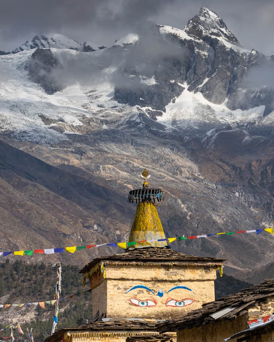 National Geographic Travelのインスタグラム：「Photo by @emilypolar | A stupa made of stone and wood stands at the entrance to the village of Samagaun in the Nubri region of Nepal. The high-altitude village is surrounded by mountains, including Manaslu, the eighth highest peak in the world.   To see more of the magnificence in the mundane, follow me @emilypolar.」