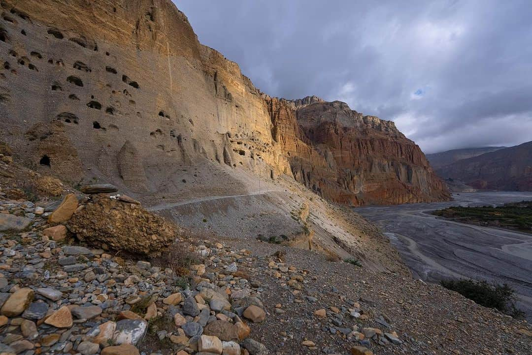 Cory Richardsさんのインスタグラム写真 - (Cory RichardsInstagram)「Words by Ben Ayers @jetbutterflies // In the wide desert of Upper Mustang, the road planes along canyon walls and dry mountainsides dotted with hundreds of unspeakably ancient human-made caves. The light plays a slow game of chase with the shadows cast by the highest mountains on the planet, now behind us. We sweep the corners wide, drawn to cliff-edges teetering above the braided Kali Gandaki River below. We don’t know where to look – the road, the layers of tortured mountains, or the sand-castle parapets of rock and mud towering above us.   Instead, we watch the oncoming frame-bent jeeps as they roaring around the blind corners on bald tires. In Tsarang, the drivers share a rough kindness with us. We play snooker, a game we don’t know. Cory tries and fails to find a tutorial on YouTube. Nursing warm cans of beer, we realize the drivers don’t know how to play either.   The evening passes in one long, impossible game of scratches and flubs until the young man running the hall flicks the light switch and kicks us out into the cold, thin air of a star-streaked night.  @vacheronconstantin」11月17日 3時42分 - coryrichards