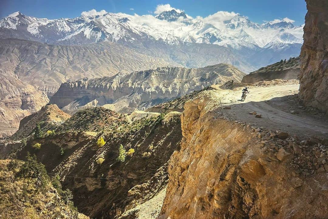 Cory Richardsのインスタグラム：「Words by Ben Ayers @jetbutterflies // In the wide desert of Upper Mustang, the road planes along canyon walls and dry mountainsides dotted with hundreds of unspeakably ancient human-made caves. The light plays a slow game of chase with the shadows cast by the highest mountains on the planet, now behind us. We sweep the corners wide, drawn to cliff-edges teetering above the braided Kali Gandaki River below. We don’t know where to look – the road, the layers of tortured mountains, or the sand-castle parapets of rock and mud towering above us.   Instead, we watch the oncoming frame-bent jeeps as they roaring around the blind corners on bald tires. In Tsarang, the drivers share a rough kindness with us. We play snooker, a game we don’t know. Cory tries and fails to find a tutorial on YouTube. Nursing warm cans of beer, we realize the drivers don’t know how to play either.   The evening passes in one long, impossible game of scratches and flubs until the young man running the hall flicks the light switch and kicks us out into the cold, thin air of a star-streaked night.  @vacheronconstantin」