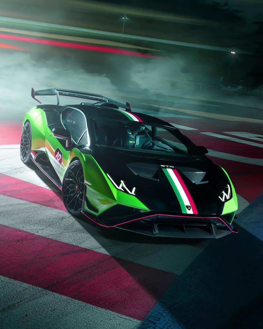 ランボルギーニのインスタグラム：「Soul of the road. Racing vocation. We introduce you to Huracán STO SC 10° Anniversario, a tribute to 10 years of Lamborghini Squadra Corse. With its new livery inspired by the SC63 and an original performance kit, this specimen has two hearts that beat in unison: the beating heart of both road and track.   #Lamborghini #LamborghiniSc」