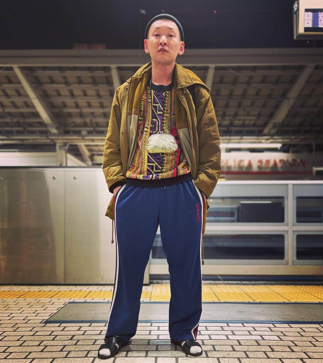 市川刺身さんのインスタグラム写真 - (市川刺身Instagram)「今日の服装。 大阪NGKに出させていただく日。  中野で購入した金の部分がたくさんのセーターに黒BENZで購入したコート。 最高円寺のジャージ。 ROTOTOの黒ニット帽に黒の便所サンダルで金のがま口にmont-bellのメッシュリュック。  大阪NGKに出させて頂いて合間にゆにばーすの川瀬さんに激ウマ飯をご馳走になりました。 よる公演までの合間で川瀬さんと僕の大好きな十四才とハラノムシに行きました。 よる公演にはダイタクさんとキンボシさんもいてみんなで泊まりたくなりました。 ダイタクさんと急ぎで新幹線に乗り込んで発車ギリギリにホームでビールを買って頂きました。 お腹空いたと言っていたら『車内販売買ってやるよ！』と言ってくれたのですが東京まで車内販売1度も来ませんでした。 東京着いたホームで撮りました。 明日は幕張に出させて頂きます。 たくさん舞台に立てて嬉しいです。 もっとたくさんお目にかかれるようがんばります。 NGKさんありがとうございます。  #今日着た服 #ファッション #古着 #大阪 #十四才 #ハラノムシ #ダイタク #ゆにばーす #キンボシ」11月16日 22時57分 - soitsudoitsu