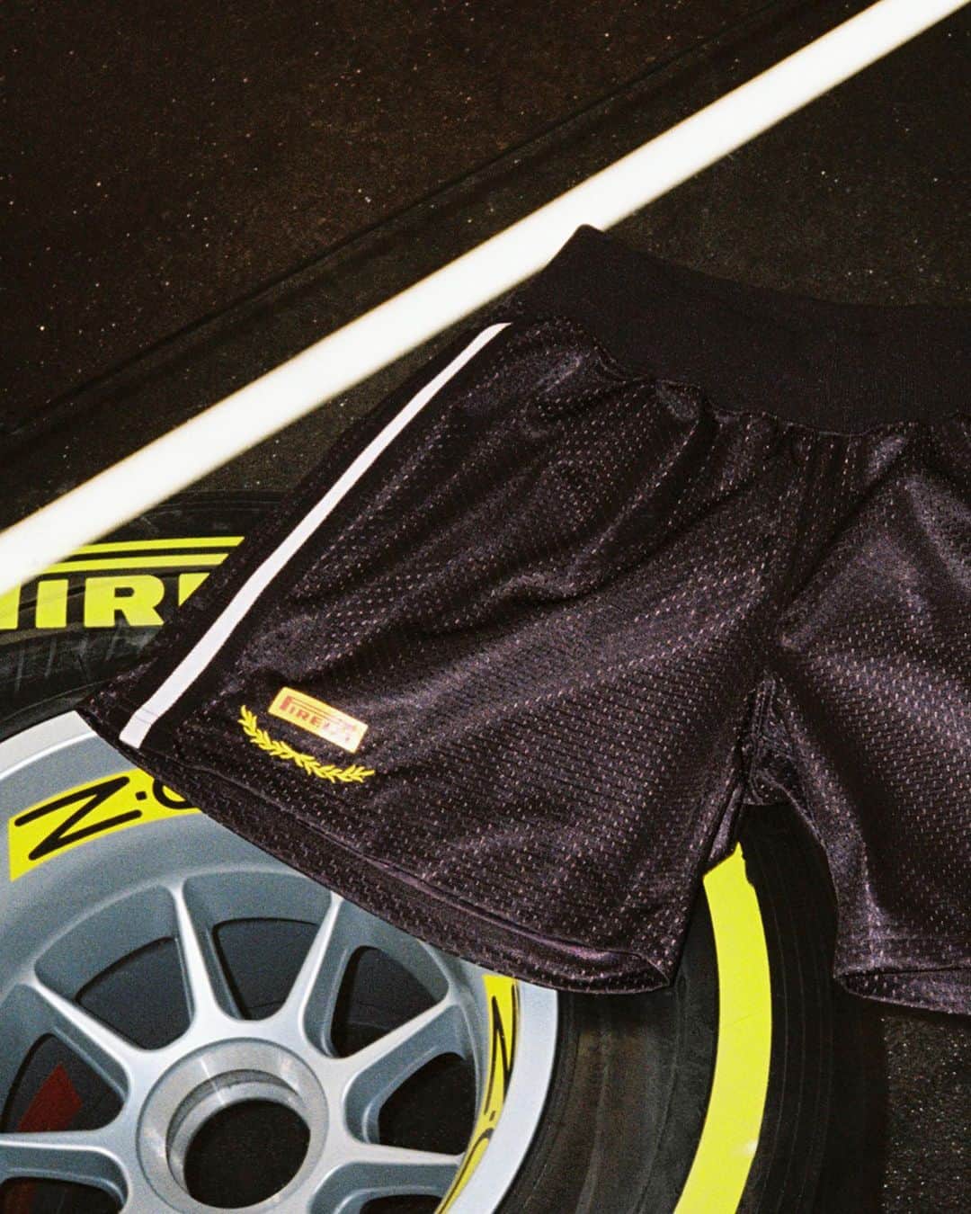 Flight Clubのインスタグラム：「Lights Out. Shop our racing-inspired collaboration with acclaimed tire manufacturer Pirelli. The limited-edition drop features premium Long Sleeve Tees, a Mesh Short and Racing Cap, finished with custom gold leaf embroidery and signature Pirelli branding. Made in Japan. Available online now.」