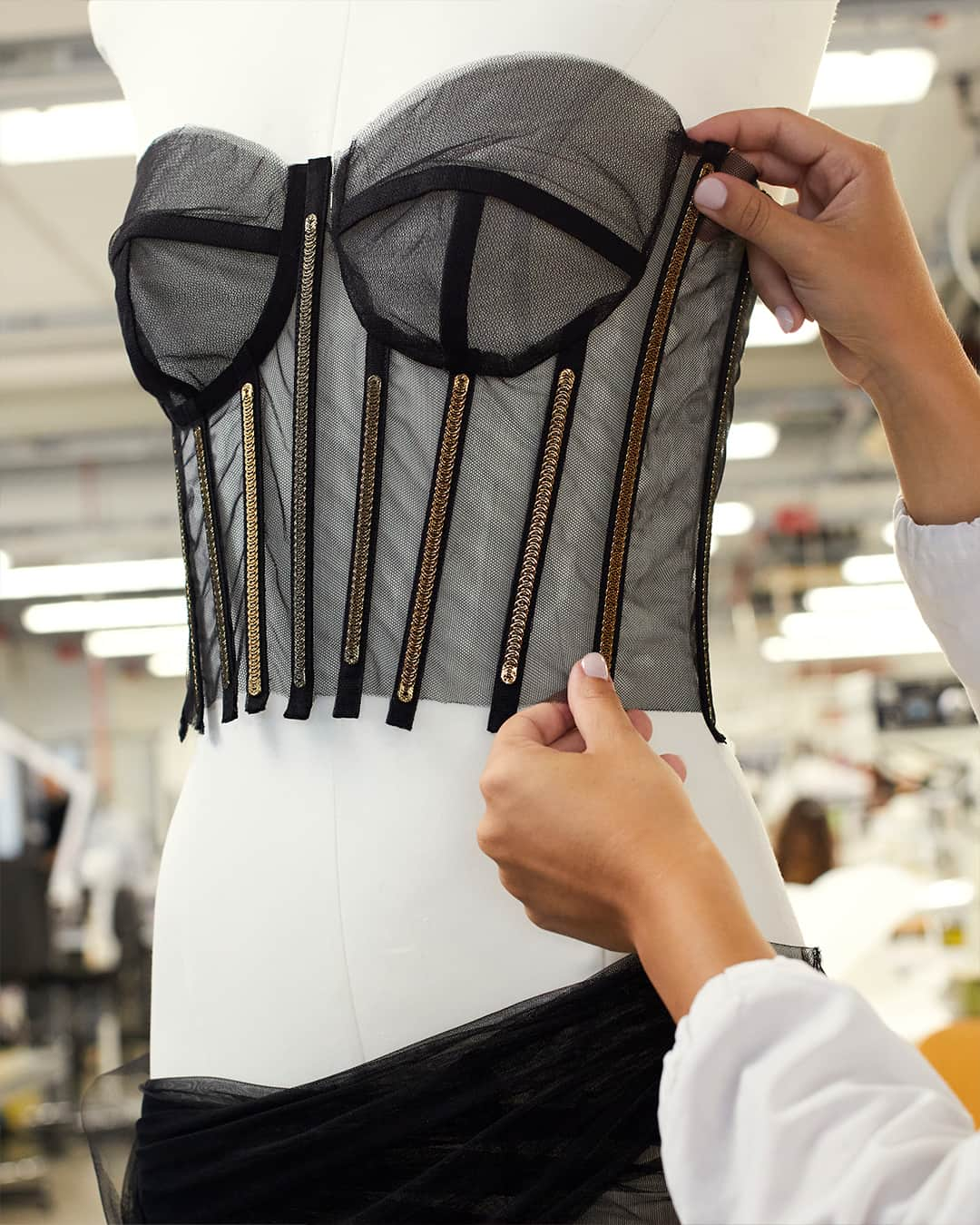 ドルチェ&ガッバーナのインスタグラム：「Behind the seams: #DolceGabbana's dedication to craftsmanship. Skilful hands unveil a captivating story of unwavering dedication and #MadeInItaly artistry. An internal boned bustier adorned with golden metal bones and hand-stitched tulle draping is a testament to #DGFattoAMano.」